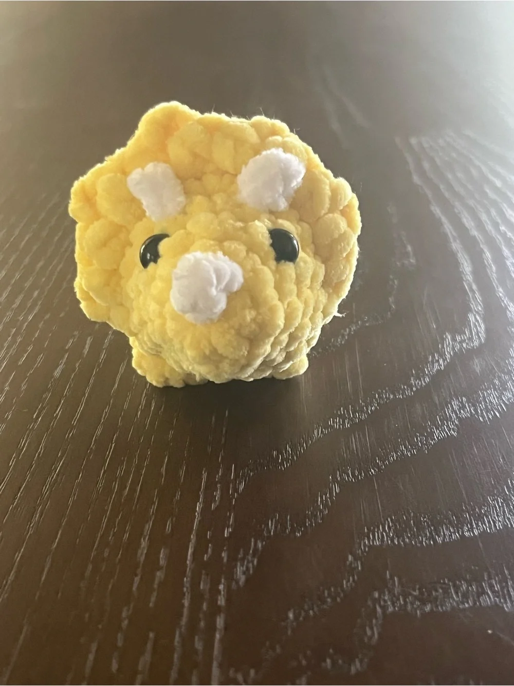 Crocheted baby triceratops dinosaur